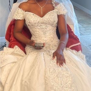 Beautifully beaded mermaid style wedding dress with cathedral length train.